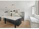 Bright kitchen with stainless appliances, white cabinets, and large black island with marble countertop at 13618 Tranquil Day Dr, Matthews, NC 28105