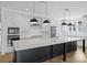 Bright kitchen with stainless appliances, white cabinets, and large black island with marble countertop at 13618 Tranquil Day Dr, Matthews, NC 28105
