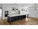 Elegant kitchen featuring a large island with seating, pendant lighting, and modern appliances at 13618 Tranquil Day Dr, Matthews, NC 28105