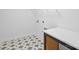 Bright laundry room with patterned tile flooring, white cabinets, and countertops at 13618 Tranquil Day Dr, Matthews, NC 28105
