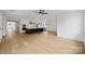 Open-concept living area adjacent to modern kitchen, featuring hardwood floors and ample natural light at 13618 Tranquil Day Dr, Matthews, NC 28105