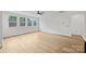 Bright living room with large windows, wood floors, and recessed lights at 13618 Tranquil Day Dr, Matthews, NC 28105