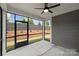 Relaxing screened-in porch with a ceiling fan, overlooking a landscaped backyard with a privacy fence at 13618 Tranquil Day Dr, Matthews, NC 28105