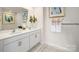Bathroom with double vanity sinks, white cabinetry, and decorative accents at 1415 5Th Street Ne Dr, Hickory, NC 28601