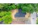 An aerial view shows the home's roof and backyard space surrounded by trees with street access and a parked truck at 1440 10Th Sw Ave, Hickory, NC 28602