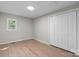 A bedroom with a double door closet and light-colored laminate flooring at 1440 10Th Sw Ave, Hickory, NC 28602