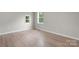 Bright bedroom features two windows for natural light and lovely wood laminate flooring at 1440 10Th Sw Ave, Hickory, NC 28602