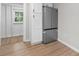 Kitchen area with stainless steel refrigerator and view into another room at 1440 10Th Sw Ave, Hickory, NC 28602