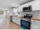 Well-lit kitchen boasts stainless steel appliances, wood countertops, and white subway tile at 1440 10Th Sw Ave, Hickory, NC 28602