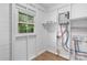A utility room featuring a window, a tankless water heater, and a new laminate floor at 1440 10Th Sw Ave, Hickory, NC 28602