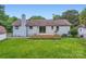 White brick house with a new backyard deck and well-manicured lawn at 1515 Edgewater Dr, Charlotte, NC 28210