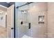 Bathroom features a modern shower with glass door and tiled walls at 1515 Edgewater Dr, Charlotte, NC 28210