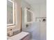 Bathroom with illuminated mirror, white marble tile and modern vanity at 1515 Edgewater Dr, Charlotte, NC 28210