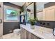 Stylish bathroom with dark walls, wooden vanity and modern fixtures at 1515 Edgewater Dr, Charlotte, NC 28210