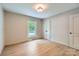 Neutral-toned bedroom with hardwood floors, closet and natural light at 1515 Edgewater Dr, Charlotte, NC 28210