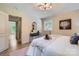 Bright bedroom with doorway view, light walls and a modern chandelier at 1515 Edgewater Dr, Charlotte, NC 28210