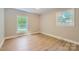 Inviting, naturally lit room with bright hardwood floors and two large windows at 1515 Edgewater Dr, Charlotte, NC 28210