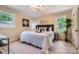 Bright bedroom features a modern chandelier and natural light from two windows at 1515 Edgewater Dr, Charlotte, NC 28210