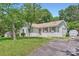 The home features a driveway and a well-kept lawn, adding to its welcoming charm at 1515 Edgewater Dr, Charlotte, NC 28210