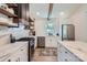 Modern kitchen with marble countertops, stainless steel appliances, and open shelving at 1515 Edgewater Dr, Charlotte, NC 28210