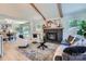 Cozy living room with a fireplace, wood beams, and an open floor plan to the dining area at 1515 Edgewater Dr, Charlotte, NC 28210