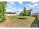 Fenced backyard showing a small tree, a patio and green grass at 160 Tanner Loop, Troutman, NC 28166