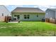 Green backyard featuring a sliding glass door, a gray patio, and a privacy fence at 160 Tanner Loop, Troutman, NC 28166