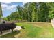 Level backyard featuring a patio, barbecue grill and wooden fence at 160 Tanner Loop, Troutman, NC 28166