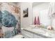 Stylish bathroom featuring granite counters, updated fixtures, and shower with nautical shower curtain at 160 Tanner Loop, Troutman, NC 28166