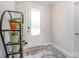 Bright entryway features a glass-paneled door, neutral walls, and a decorative rug with a plant display at 160 Tanner Loop, Troutman, NC 28166