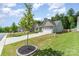 A well-maintained home exterior with a two-car garage and lush green lawn under a partly cloudy sky at 160 Tanner Loop, Troutman, NC 28166