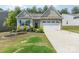 Charming single-story home with a stone and siding exterior and well-manicured front yard landscaping at 160 Tanner Loop, Troutman, NC 28166