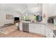 Open kitchen with white cabinets, stainless appliances, eat-in island, and access to dining area at 160 Tanner Loop, Troutman, NC 28166