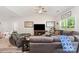 Open living room with large sectional, ceiling fan, and decorative wall art providing a cozy and inviting space at 160 Tanner Loop, Troutman, NC 28166