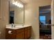 Functional bathroom featuring a double vanity, and adjacent main bedroom view at 165 Kimball Rd, China Grove, NC 28023