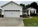 Charming home featuring a two-car garage, brick accents, and a well-manicured lawn at 165 Kimball Rd, China Grove, NC 28023