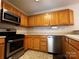 Kitchen showcasing stainless steel oven, microwave and wooden cabinetry at 165 Kimball Rd, China Grove, NC 28023