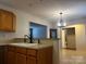 View of the kitchen sink and cabinets, looking through dining room and other rooms in the house at 165 Kimball Rd, China Grove, NC 28023