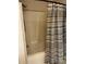 Simple shower featuring a light brown shower surround and horizontally striped shower curtain at 165 Kimball Rd, China Grove, NC 28023