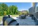 Backyard showcasing a stone patio, gazebo, dining and seating sets, and lawn at 17228 River Race Dr, Huntersville, NC 28078