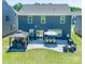 Backyard featuring dark siding home, a stone patio, gazebo, dining set, and outdoor seating at 17228 River Race Dr, Huntersville, NC 28078