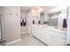 Bright bathroom showcasing double vanity, white cabinetry, tile flooring, and large mirror at 17228 River Race Dr, Huntersville, NC 28078