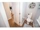 A half bath with a white toilet and wall art is conveniently located near the living spaces at 17228 River Race Dr, Huntersville, NC 28078