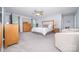Spacious bedroom features a large bed, dresser, ceiling fan, and windows offering plenty of natural light for a relaxing atmosphere at 17228 River Race Dr, Huntersville, NC 28078