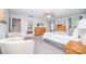 Spacious bedroom with a large bed, dresser, ceiling fan, and windows offering plenty of natural light for a relaxing atmosphere at 17228 River Race Dr, Huntersville, NC 28078