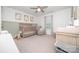 Bright Bedroom with a crib, rocker, and changing table, creating a peaceful and organized space for your little one at 17228 River Race Dr, Huntersville, NC 28078