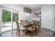 The dining room has a wood table, six chairs, sliding glass door to the yard and decorative shelving at 17228 River Race Dr, Huntersville, NC 28078