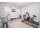 Well-lit exercise room with a rowing machine, stationary bike, weights, and a decorative wall art, perfect for staying in shape at 17228 River Race Dr, Huntersville, NC 28078