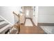 Inviting foyer with hardwood floors, decorative console table, and a staircase with a baby gate at 17228 River Race Dr, Huntersville, NC 28078