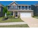 Charming two-story brick home with well-manicured lawn and attached two-car garage at 17228 River Race Dr, Huntersville, NC 28078